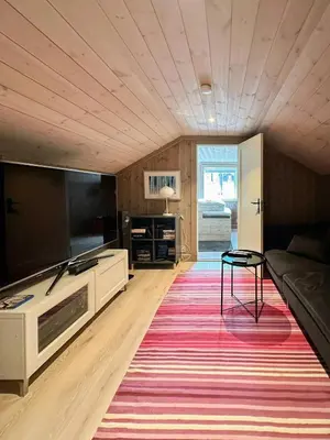 a living room with a couch and a large rug at Mountain Cabin Near Solheisen In Grøndalen in Hemsedal