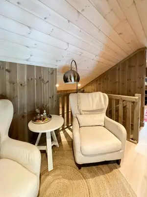 a living room with a chair and a table at Mountain Cabin Near Solheisen In Grøndalen in Hemsedal