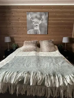 a bedroom with a bed with a picture of a deer at Family Cabin With Ski Inout At Furutangen in Vika
