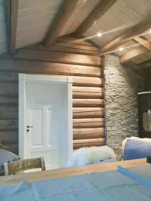 a room with a white door and a stone wall at Mountain Cabin With A View Over Jotunheimen in Tretten