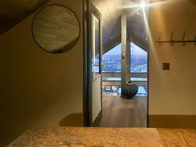a bedroom with a large window with a view at Cabin With Panoramic And Ski Trails Outside in Rauland