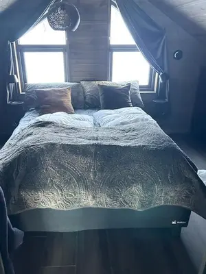 a large bed in a bedroom with a window at Cabin With Panoramic And Ski Trails Outside in Rauland