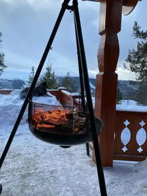 a fire grill in a swing on a porch in the snow at Family Fun Cabin In Engerdals Heart in Nymoen