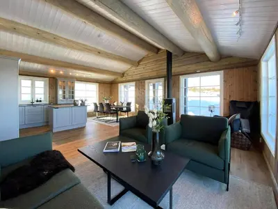 a living room with two couches and a table at Cabin With Panoramic View In Synnfjell in Nord Torpa