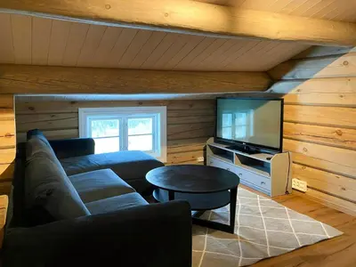 a living room with a couch and a tv at Cabin With Panoramic View In Synnfjell in Nord Torpa