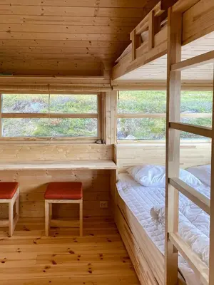 a cabin with two bunk beds and a bench at Cabin With Award-Winning Design On Norefjell in Eggedal
