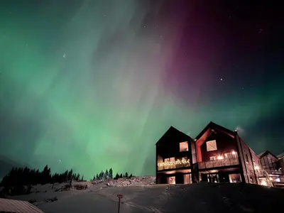 an image of a building with the aurora in the sky at Modern Apartment Overlooking Gudbrandsdalen in Øyer