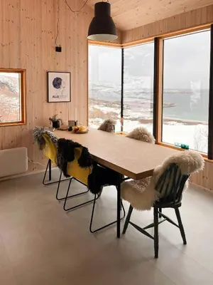 a dining room with a table and two chairs at Architect Drawn Cabin Between Sea And Mountain in Hosen