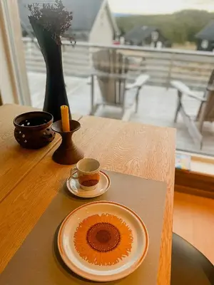 a table with a plate and a cup of coffee at Modern Family Cabin At Sjusjøen in Sjusjøen