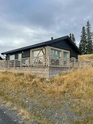 a house sitting on top of a hill at Modern Family Cabin At Sjusjøen in Sjusjøen