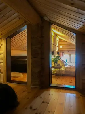 a room with a large glass door leading to a bedroom at Spacious Log Cabin Near Hardangervidda in Uvdal