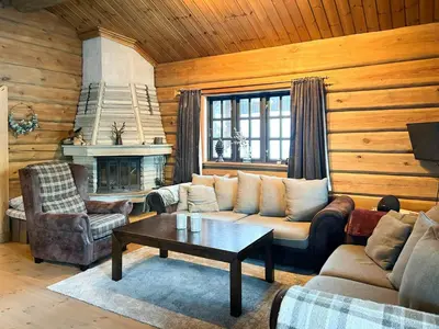 a living room with a couch and a table at Spacious Log Cabin Near Hardangervidda in Uvdal