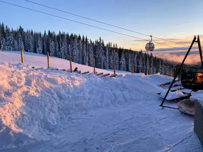 a snow covered ski slope with a ski lift at Ski Inski Out-Hytte I Hafjell Med Udsigt in Øyer