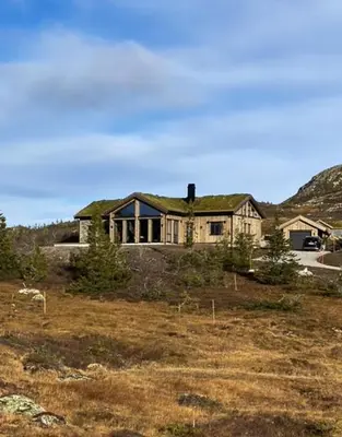 a house with a grass roof on top of a field at Mountain Home On Høgevarde With Majestic Views in Flå