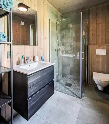 a bathroom with a sink and a shower and a toilet at Spacious Familyabin With A View On Norefjell in Noresund
