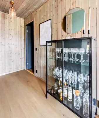a glass display case in a room with wooden walls at Spacious Familyabin With A View On Norefjell in Noresund