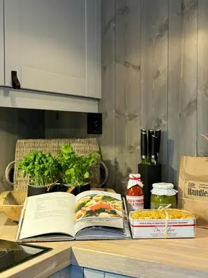 two books sitting on a kitchen counter with plants at Modern Family Cabin In Norefjell Ski-Inout in Surteberg