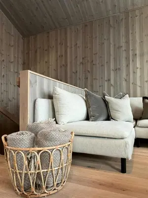 a living room with a couch and a basket at Modern Family Cabin In Norefjell Ski-Inout in Surteberg