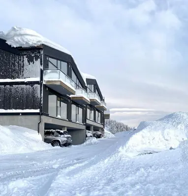 a snow covered building with a car parked in front of it at Stay At Norefjell, Ski-Inout And Panorama in Noresund