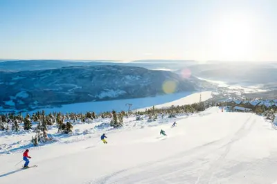 a group of people skiing down a snow covered slope at Stay At Norefjell, Ski-Inout And Panorama in Noresund