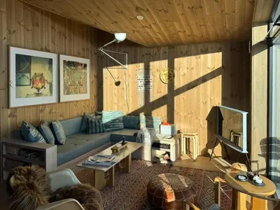 a living room with a blue couch and a fireplace at Stay At Norefjell, Ski-Inout And Panorama in Noresund