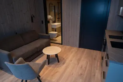 a living room with a couch and a table at Kulleseidkanalen gjestehamn in Bømlo