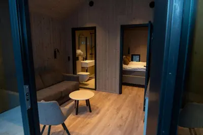 a room with a couch and a table and a bed at Kulleseidkanalen gjestehamn in Bømlo