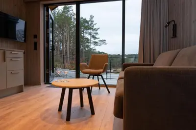 a living room with a couch and a table at Kulleseidkanalen gjestehamn in Bømlo