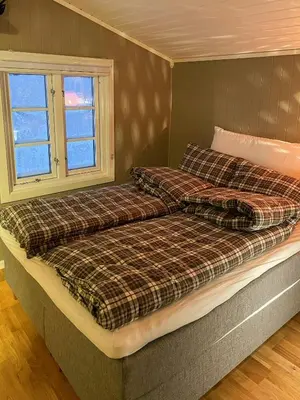 a bed in a room with two pillows on it at Family Cabin With Views In Sør-Fron in Sør-Fron