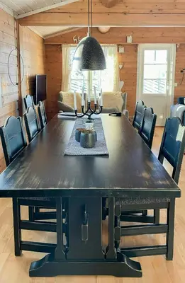 a dining room with a large black table and chairs at Family Cabin With Views In Sør-Fron in Sør-Fron