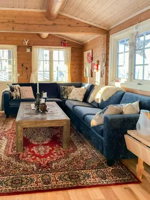 a living room with a blue couch and a coffee table at Family Cabin With Views In Sør-Fron in Sør-Fron