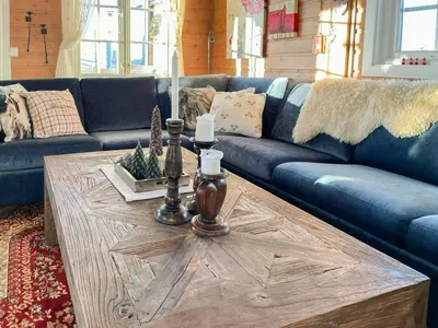 a living room with a blue couch and a wooden coffee table at Family Cabin With Views In Sør-Fron in Sør-Fron