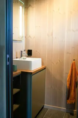 a bathroom with a sink and a mirror at Modern Mountain Cabin With Nature In Valdres in Løken