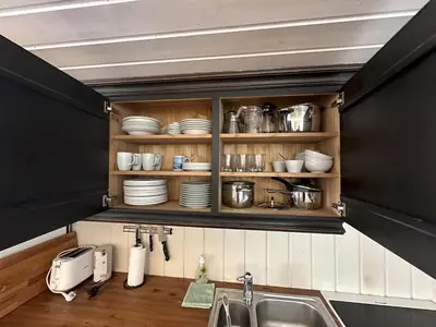 a kitchen with a sink and a shelf with dishes at Cozy Two Bedrooms Apartment With Sauna And Mountain Views in Beitostøl