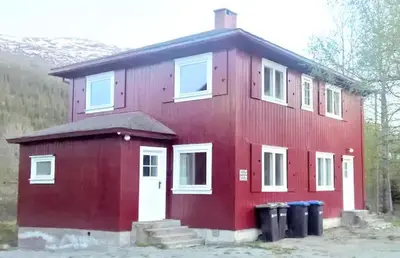 a red house with two trash cans in front of it at Hemsedal - 5 bedrooms in Fausko