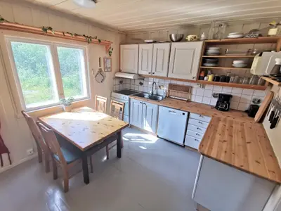 a kitchen with a wooden table and a table and chairs at Hemsedal - 5 bedrooms in Fausko