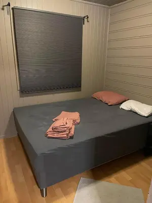 a bedroom with a bed with two towels on it at Utsikten in Trondheim