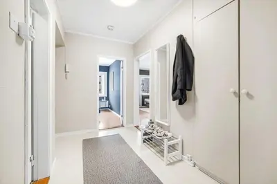 a white hallway with a walk in closet and a mirror at Central 4-bedroom by Lerkendal in Trondheim