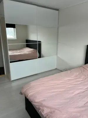 a bedroom with a mirror and a bed in it at Ski VM in Trondheim