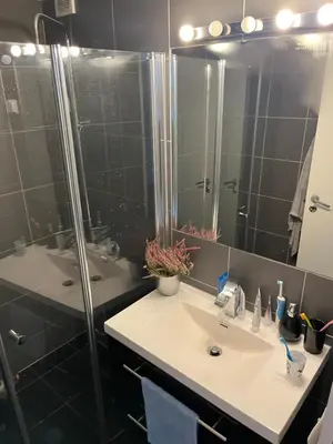 a bathroom with a sink and a shower at Ski VM in Trondheim