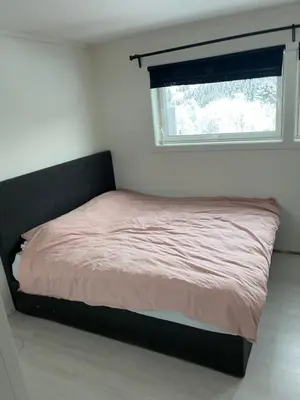 a bed in a small room with a window at Trondheim in Trondheim