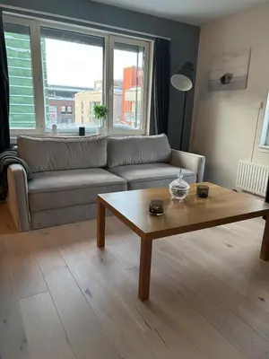 a living room with a couch and a coffee table at Penthouse in Trondheim, Solsiden in Trondheim