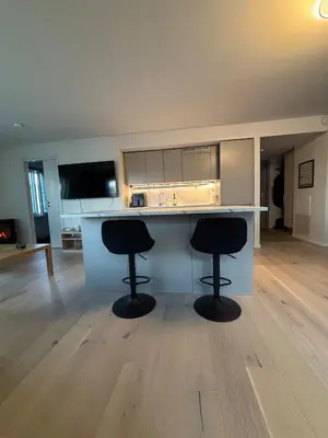 a kitchen with two black stools at a counter at Penthouse in Trondheim, Solsiden in Trondheim