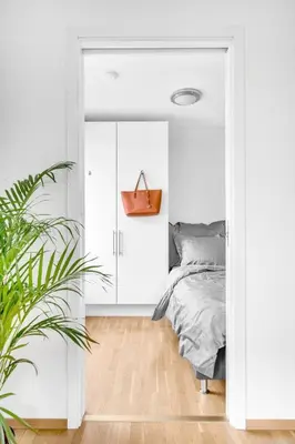 a bedroom with white walls and a bed at Penthouse in Trondheim, Solsiden in Trondheim