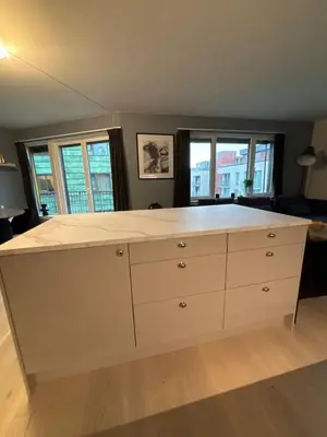 a large white counter in a room with windows at Penthouse in Trondheim, Solsiden in Trondheim