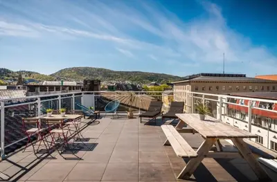 a patio with picnic tables and chairs on a building at Apartment by Torgalmenningen in Bergen