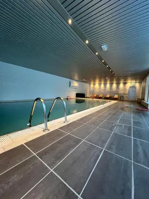 a swimming pool in a large building with a swimming pool at Voss Apartment in Oppheim Resort, pool and view in Vossevangen