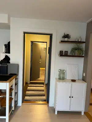 a hallway leading to a kitchen with a yellow door at Voss Apartment in Oppheim Resort, pool and view in Vossevangen