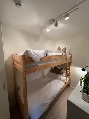 a bunk bed in the corner of a room at Voss Apartment in Oppheim Resort, pool and view in Vossevangen