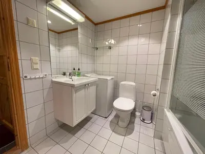 a white bathroom with a toilet and a sink at Family-Friendly Stay Near Ski Trails! in Beitostøl